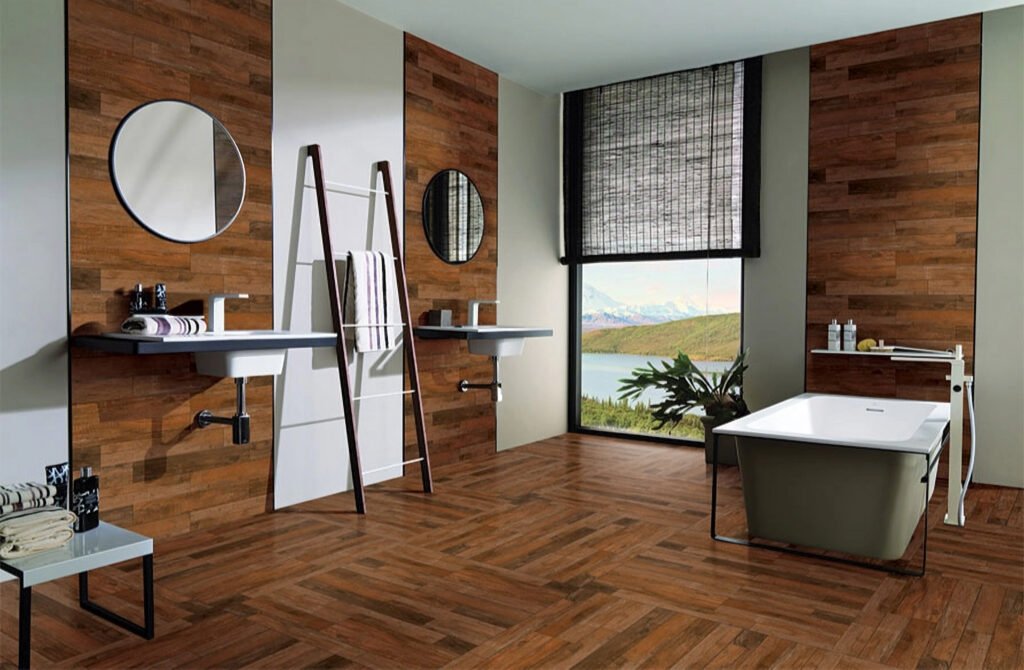 Modern bathroom with wood-paneled walls, twin sinks, round mirrors, and a rectangular bathtub. Large window displays a scenic view.