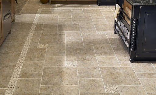 Light beige floor tiles with decorative white grout lines and patterned accents.